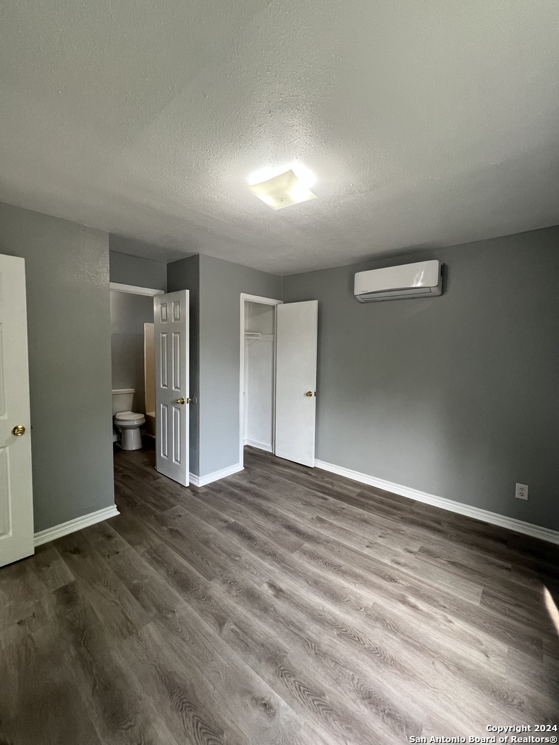 1723 West Mayfield Boulevard, Unit 4 San Antonio, TX 78211 - Photo 9 of 14 a view of an empty room with wooden floor