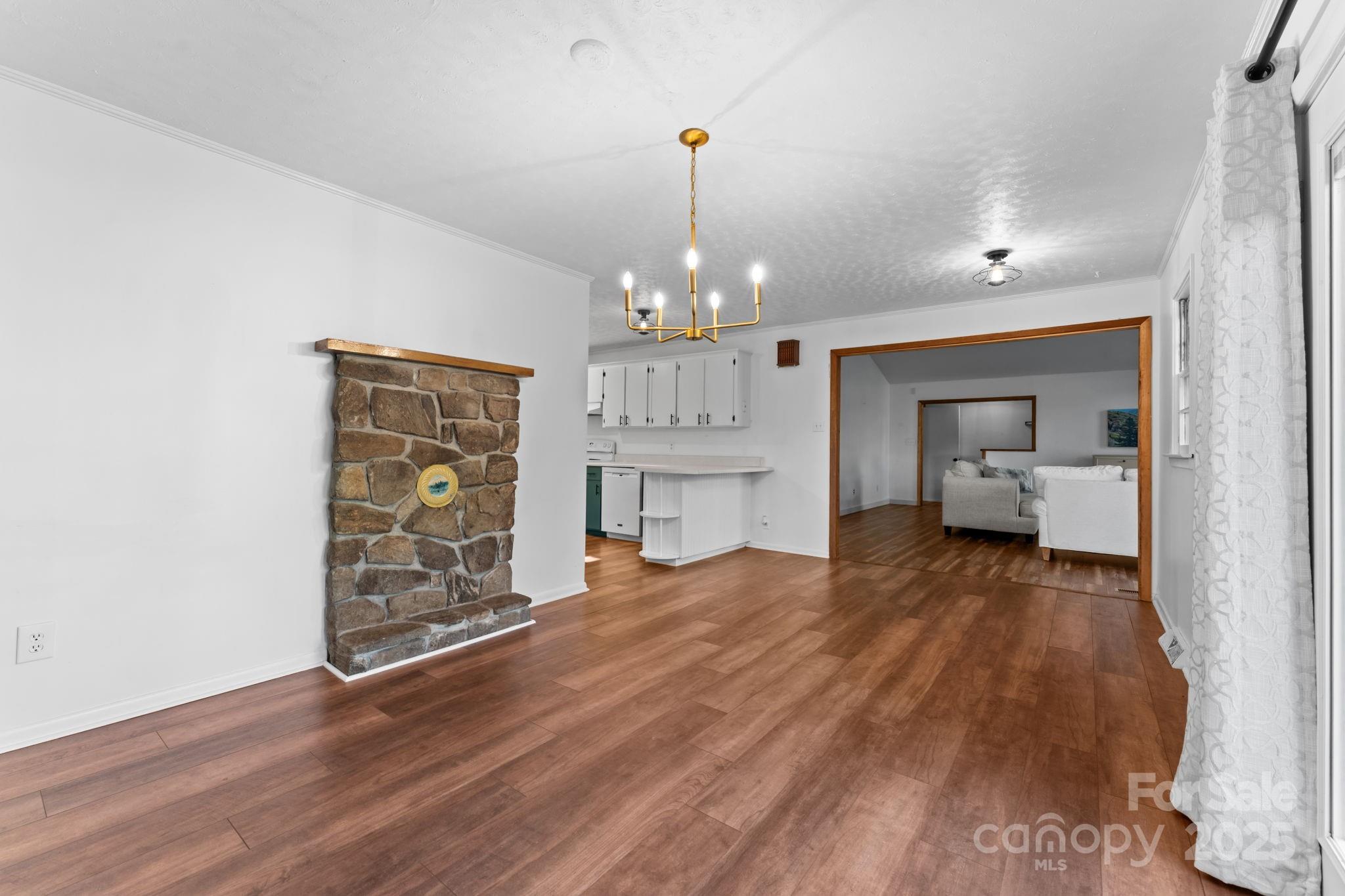 621 Kitchens Branch Road Sylva, NC 28779 - Photo 11 of 29 a view of a room with wooden floor and a ceiling fan