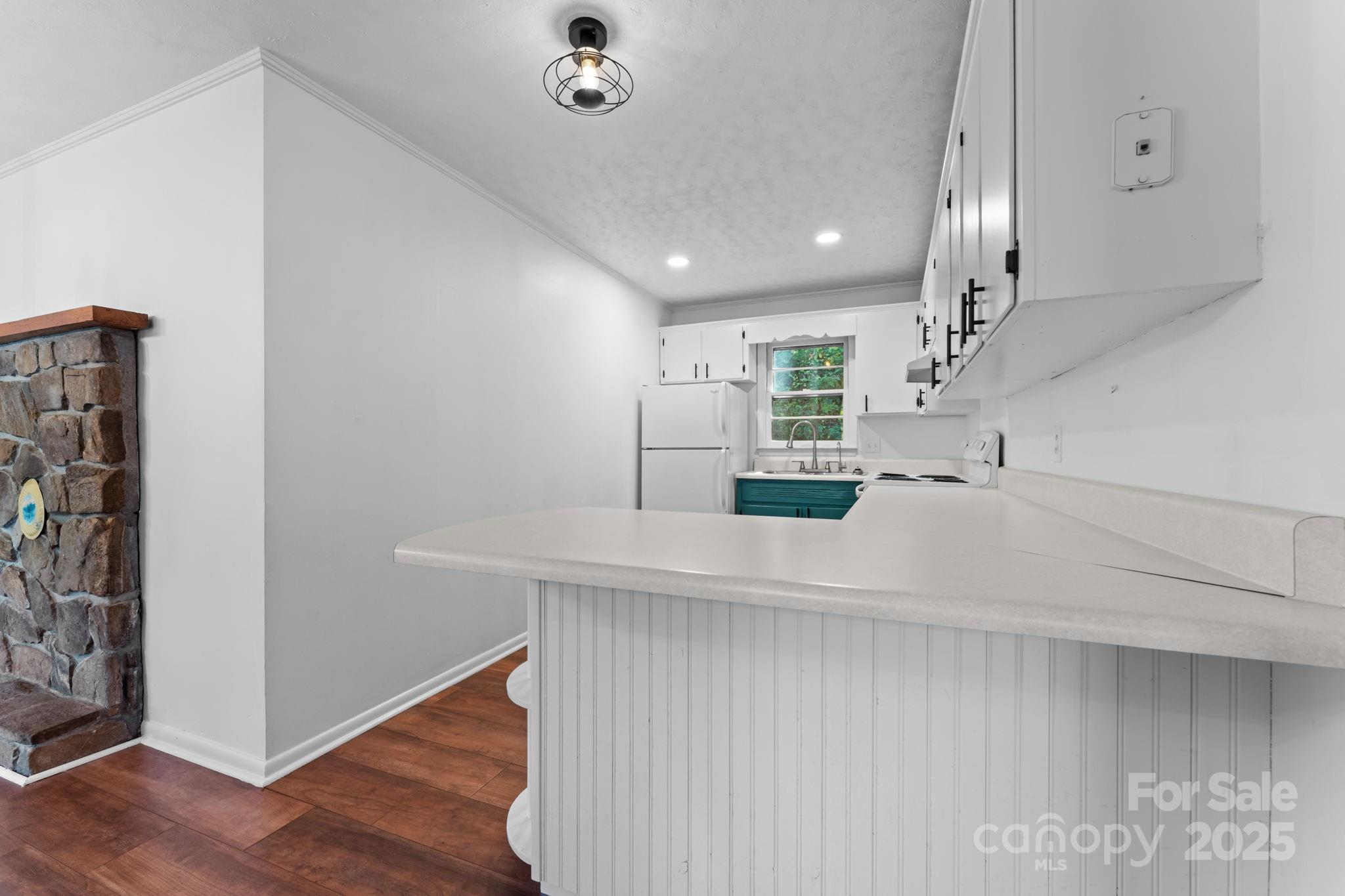 621 Kitchens Branch Road Sylva, NC 28779 - Photo 13 of 29 a kitchen with stainless steel appliances a refrigerator and wooden floor