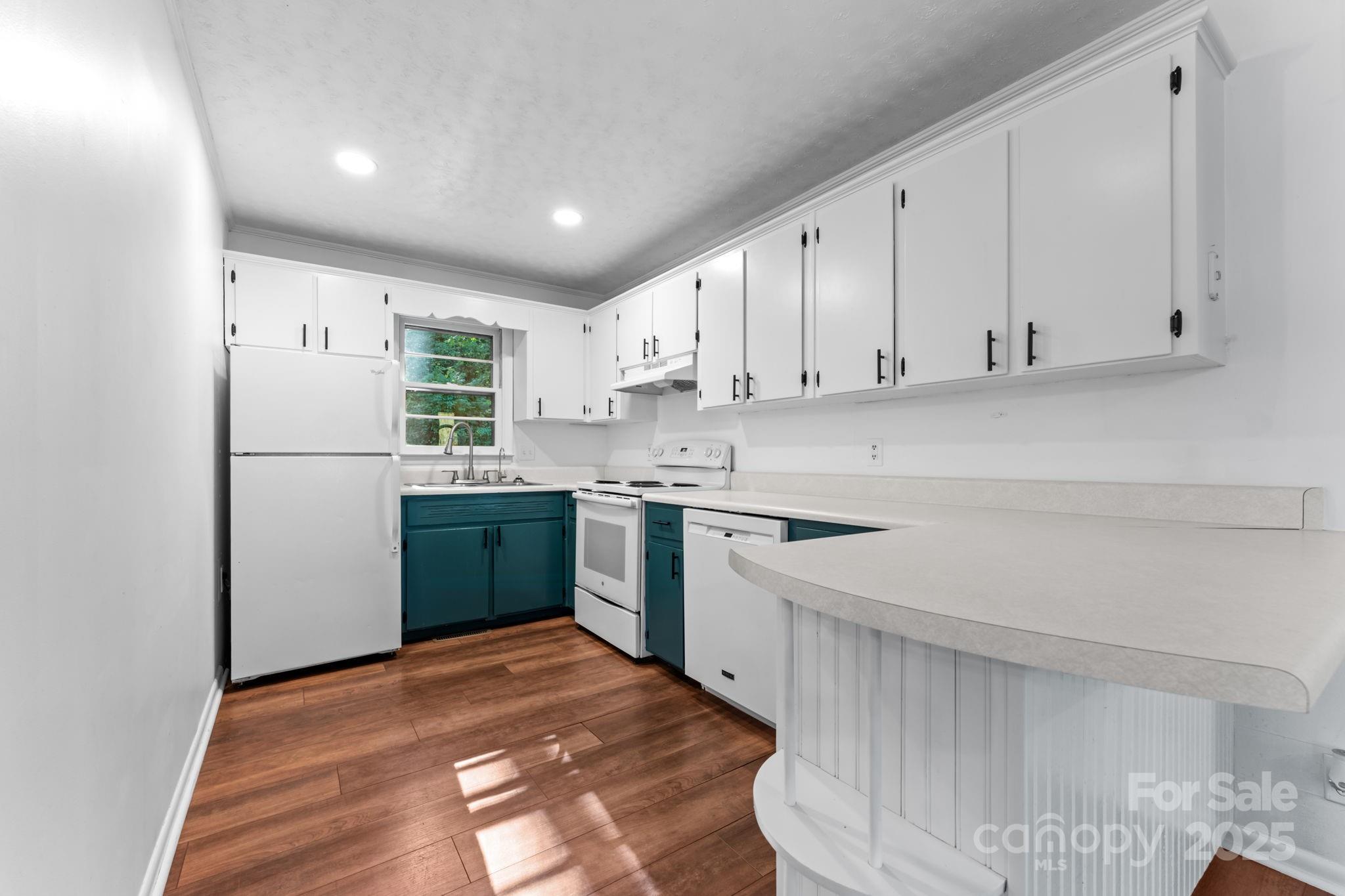 621 Kitchens Branch Road Sylva, NC 28779 - Photo 14 of 29 a kitchen with a refrigerator sink and cabinets