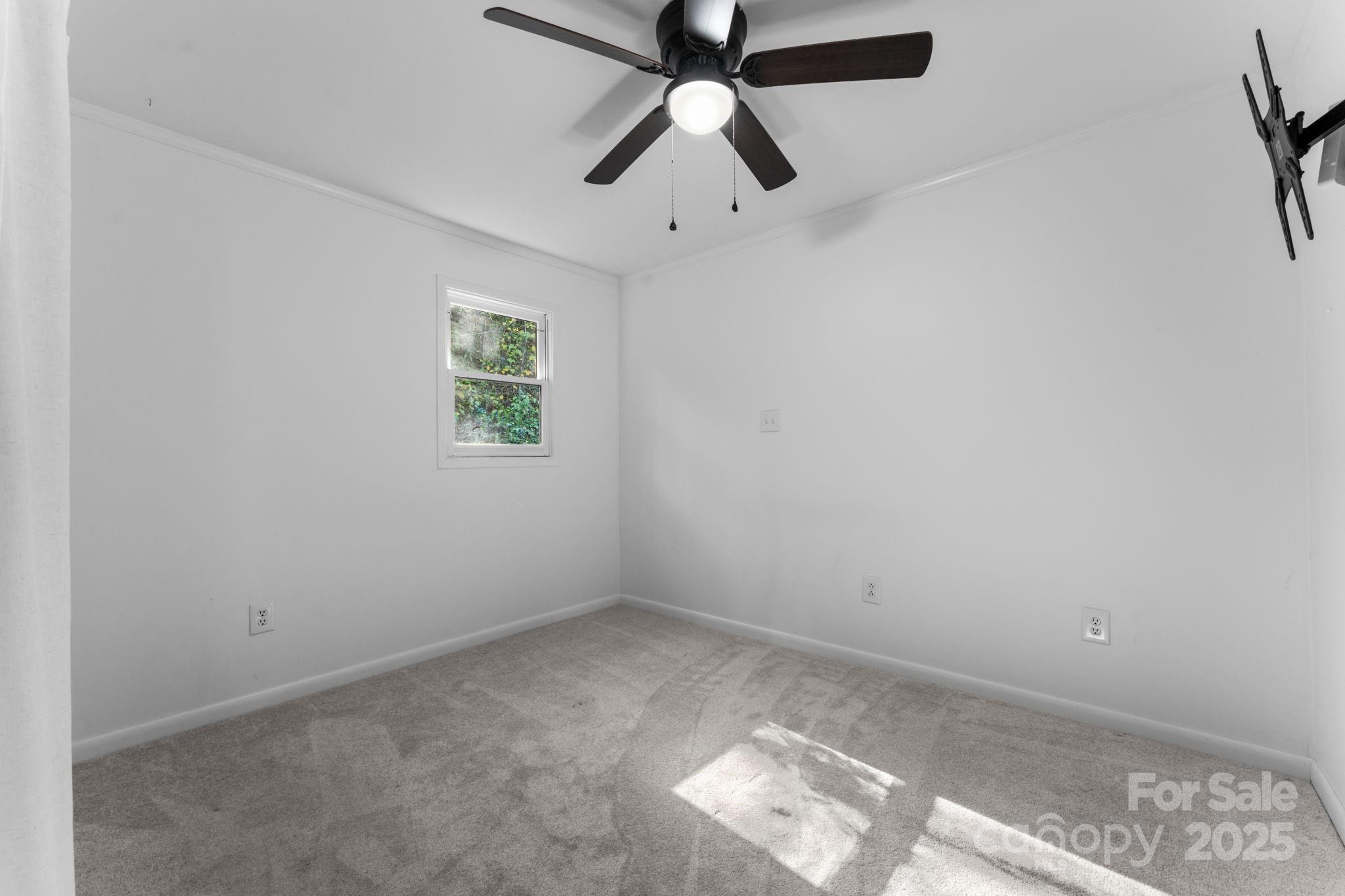 621 Kitchens Branch Road Sylva, NC 28779 - Photo 17 of 29 an empty room with a window and a fan
