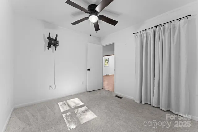 a view of empty room with ceiling fan
