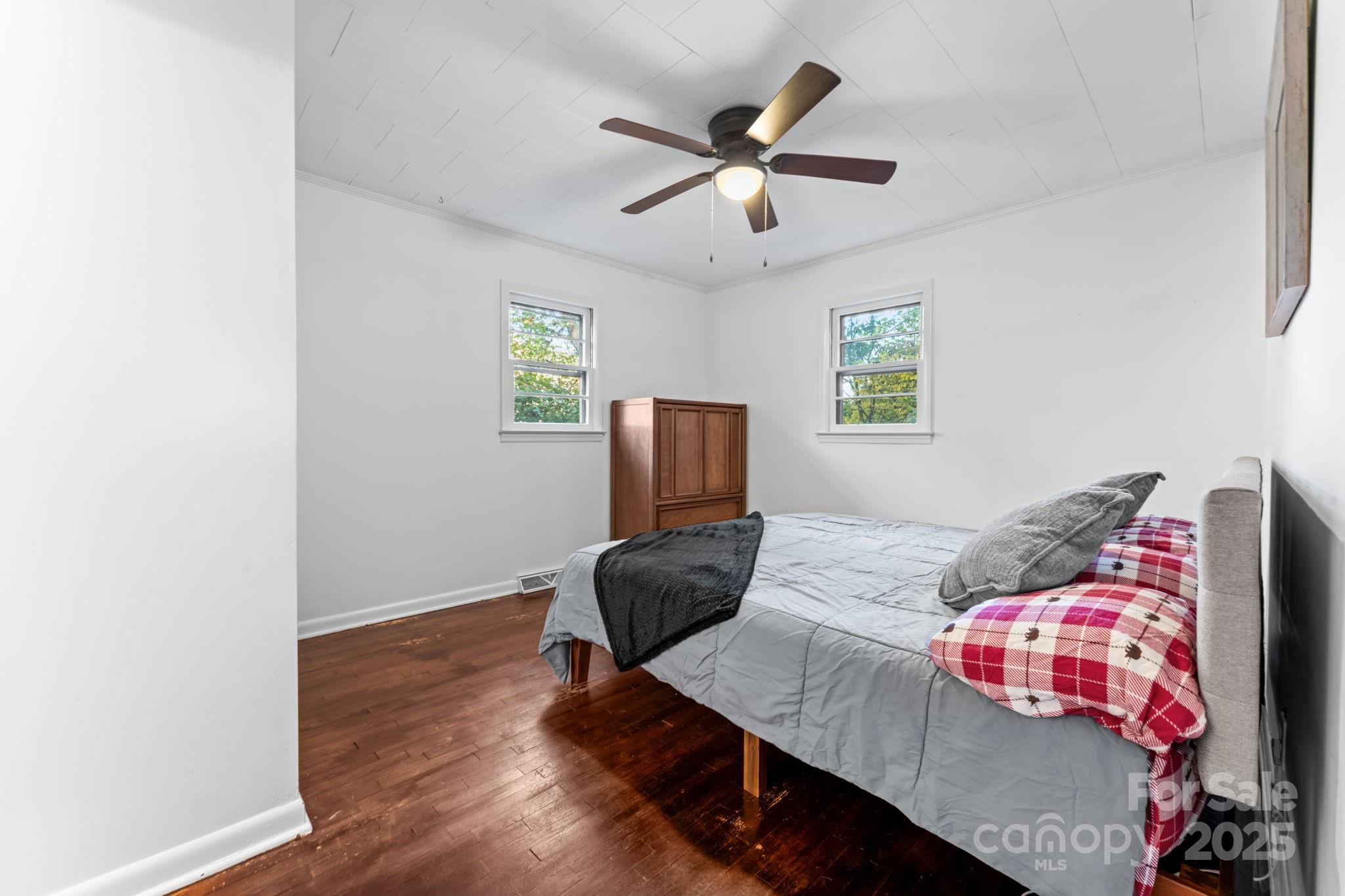 621 Kitchens Branch Road Sylva, NC 28779 - Photo 21 of 29 a bedroom with a bed and wooden floor