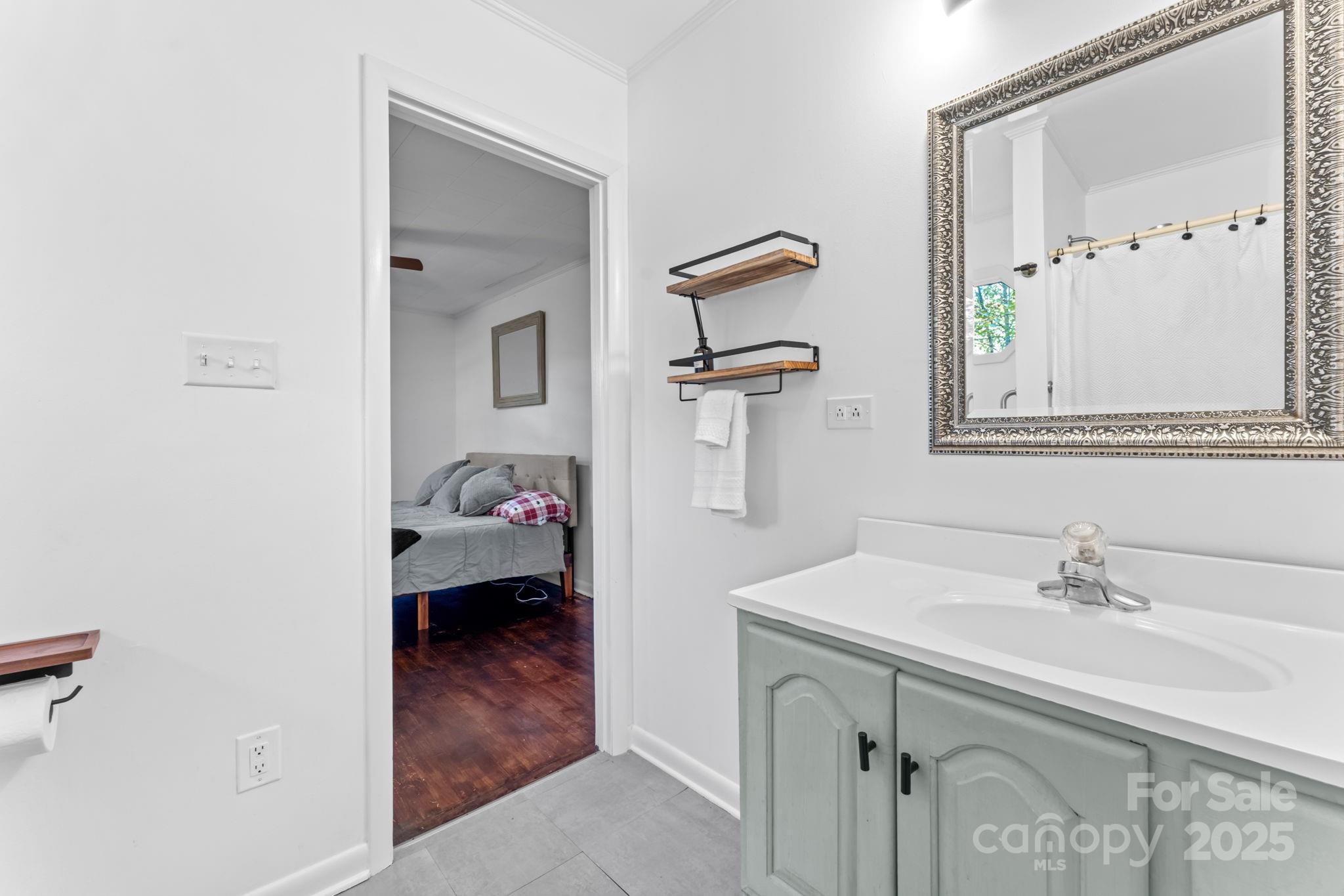 621 Kitchens Branch Road Sylva, NC 28779 - Photo 24 of 29 a en suite bathroom with a sink and mirror
