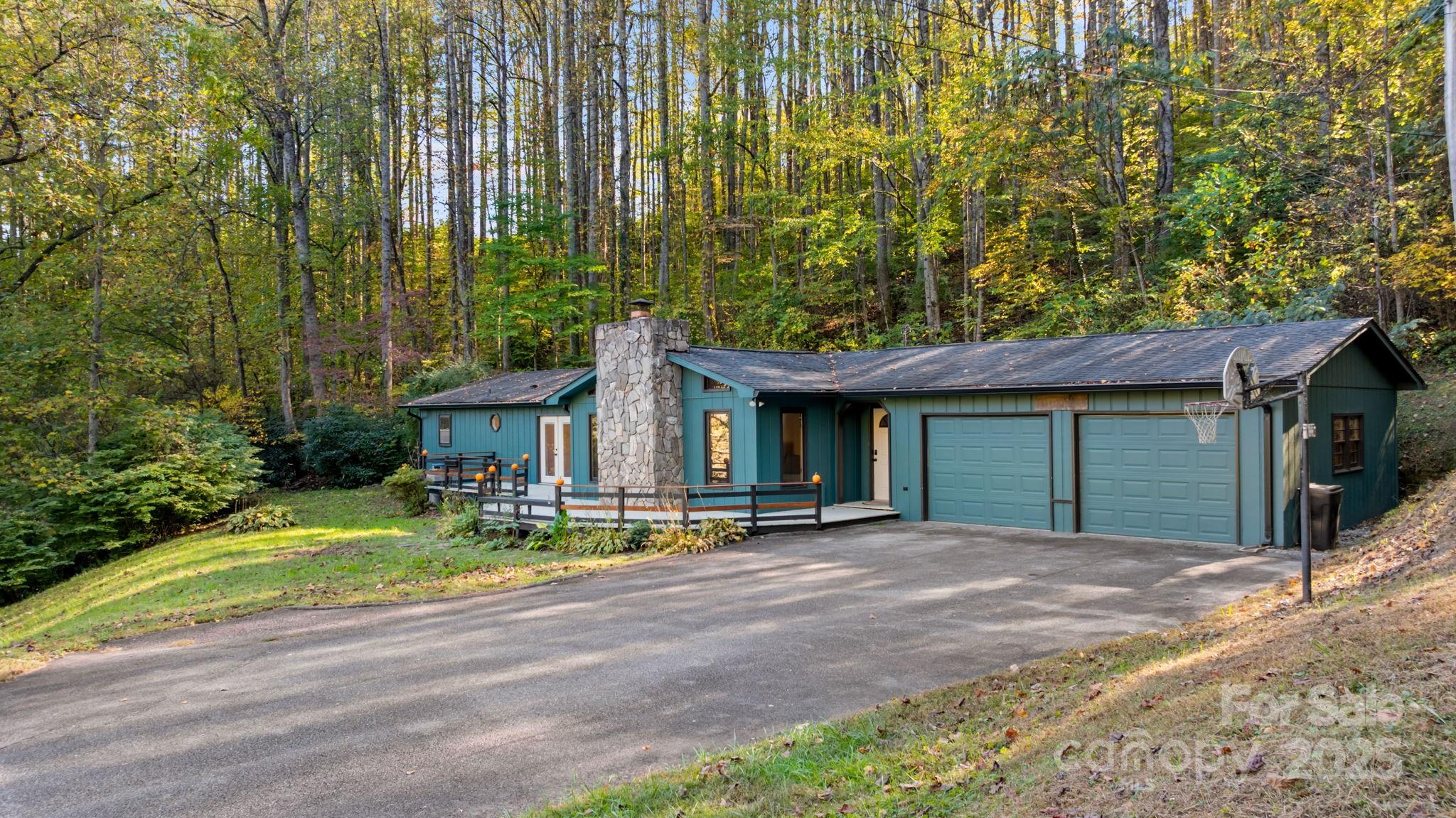 621 Kitchens Branch Road Sylva, NC 28779 - Photo 3 of 29 a view of a house with backyard and sitting area