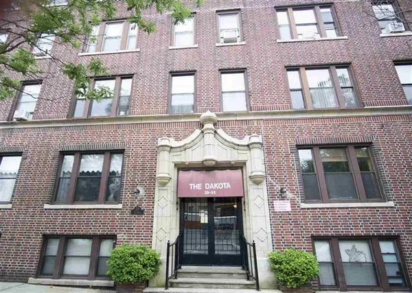 a front view of a brick building with many windows and a door