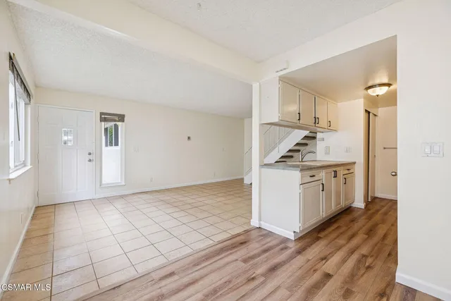 a view of a hallway with wooden floor and closet