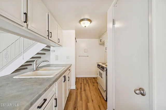 a kitchen with stainless steel appliances granite countertop a stove and a sink
