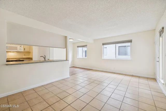 a view of a small space with wooden floor and cabinets