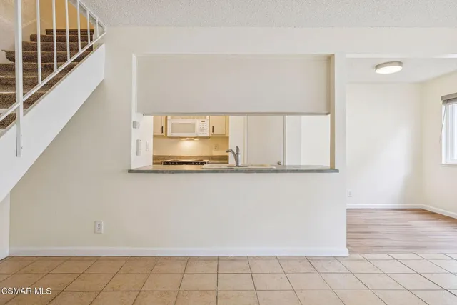 a view of a hallway view of wooden floor and staircase