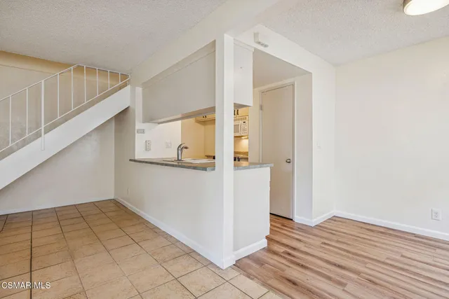 a view of kitchen with sink microwave and cabinets