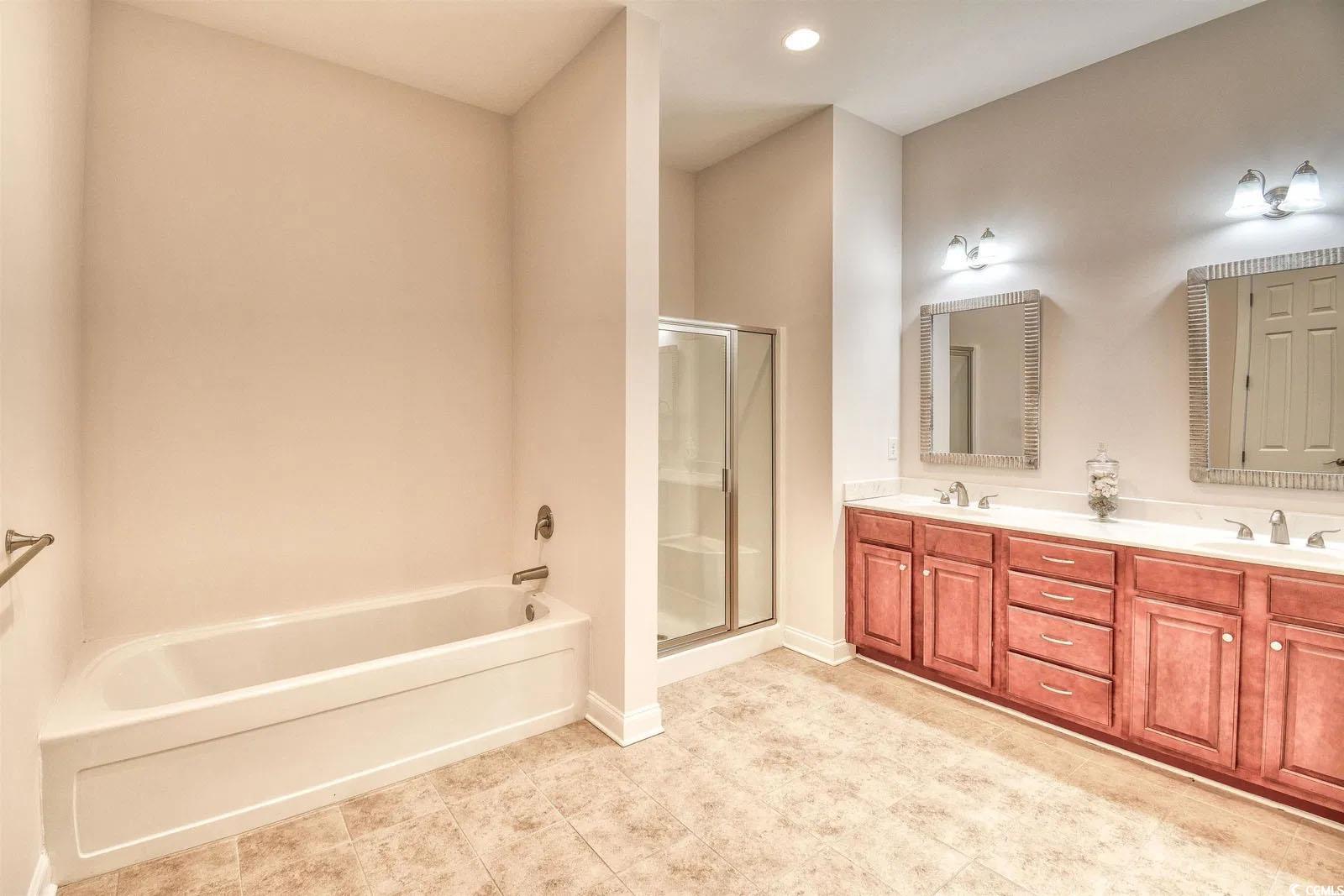 750 Shine Avenue, Unit 750 Myrtle Beach, SC 29577 - Photo 13 of 34 Bathroom with a shower stall, a garden tub, double vanity, and recessed lighting