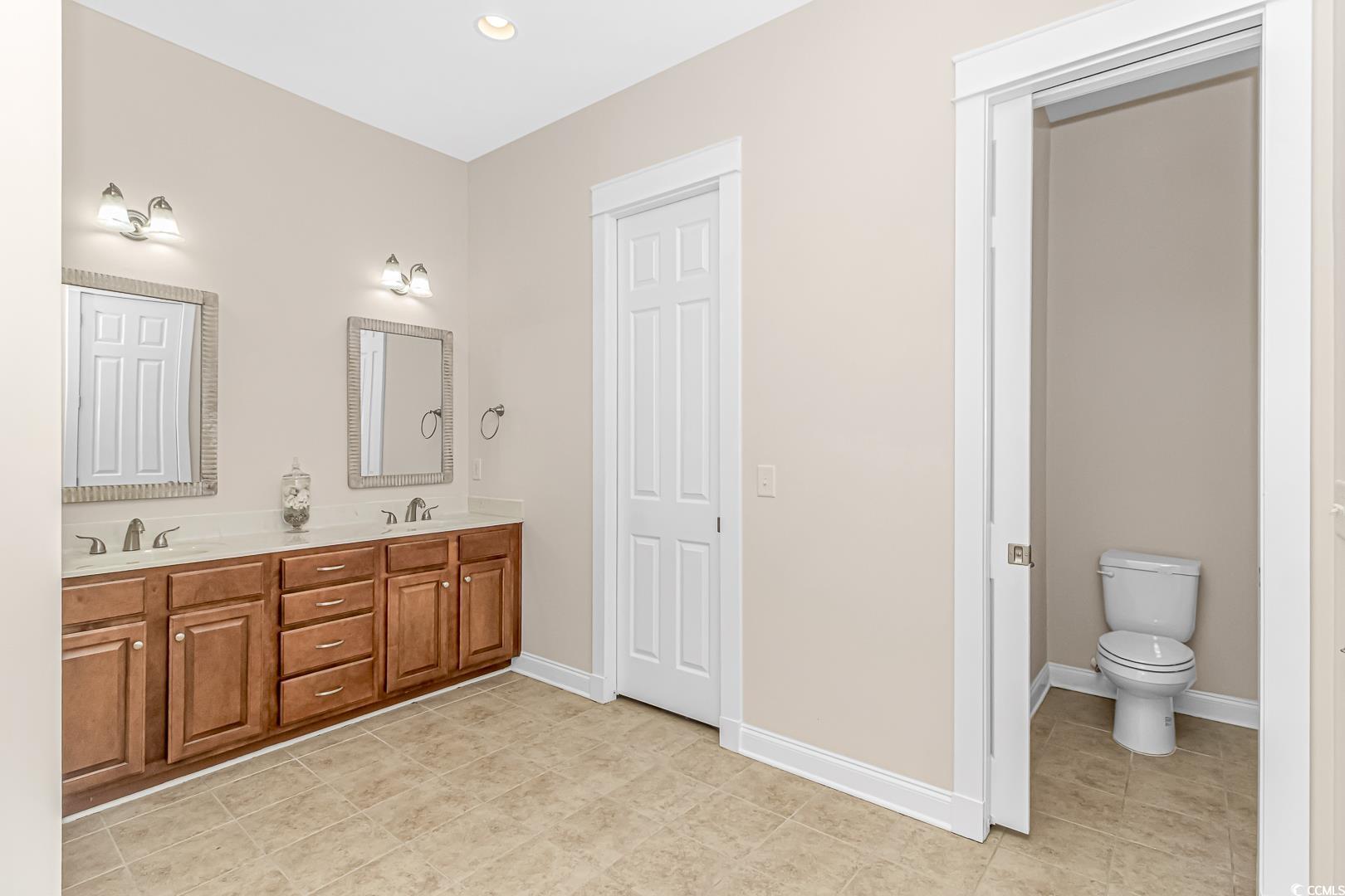 750 Shine Avenue, Unit 750 Myrtle Beach, SC 29577 - Photo 15 of 34 Bathroom featuring double vanity, recessed lighting, and light tile patterned flooring