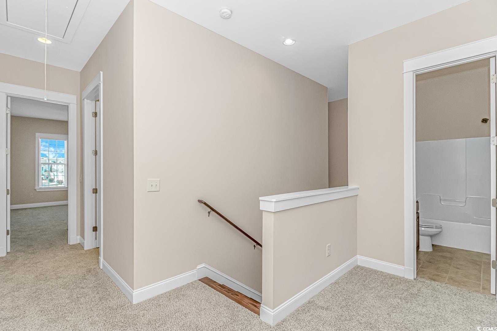 750 Shine Avenue, Unit 750 Myrtle Beach, SC 29577 - Photo 16 of 34 Hall with an upstairs landing, attic access, light colored carpet, and recessed lighting