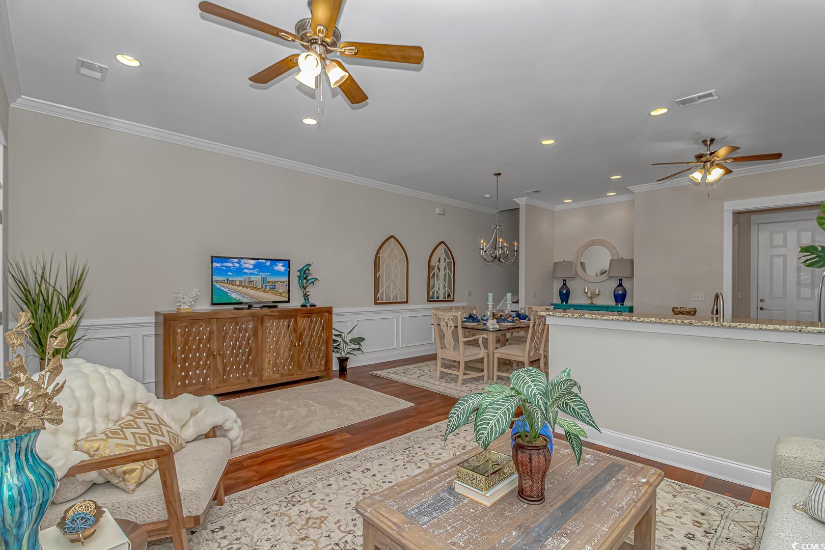 750 Shine Avenue, Unit 750 Myrtle Beach, SC 29577 - Photo 4 of 34 Living room featuring ceiling fan, recessed lighting, crown molding, a decorative wall, and wood finished floors