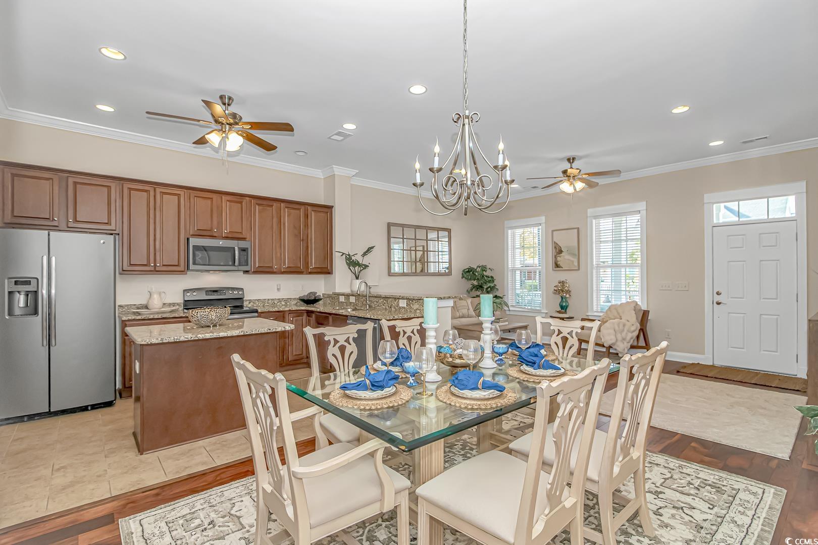 750 Shine Avenue, Unit 750 Myrtle Beach, SC 29577 - Photo 9 of 34 Dining area featuring a ceiling fan, ornamental molding, a chandelier, recessed lighting, and light wood-type flooring