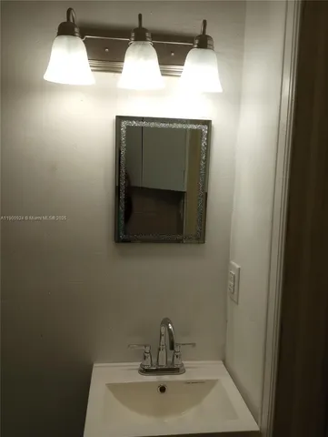 a bathroom with a sink and mirror