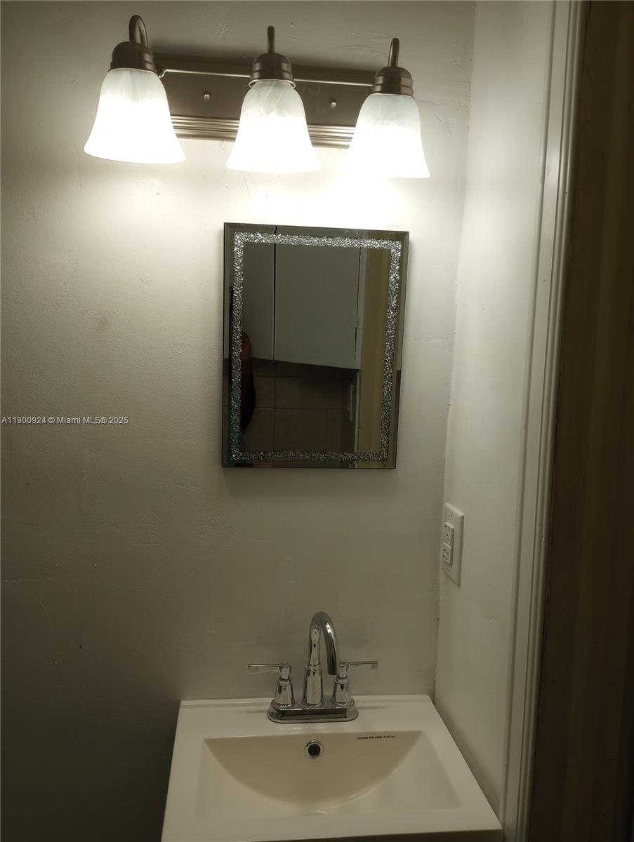 a bathroom with a sink and mirror