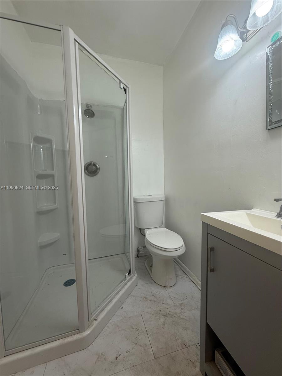 1918 Northwest 82nd Street Miami, FL 33147 - Photo 12 of 15 a bathroom with a toilet sink and shower