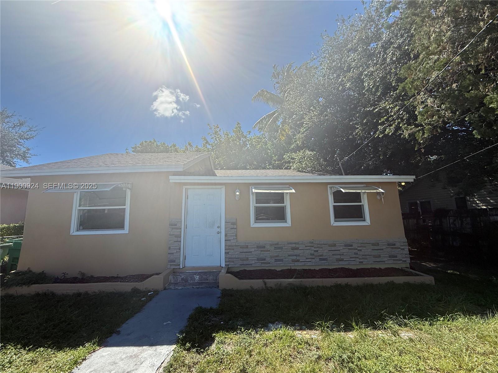 1918 Northwest 82nd Street Miami, FL 33147 - Photo 2 of 15 a front view of a house with yard