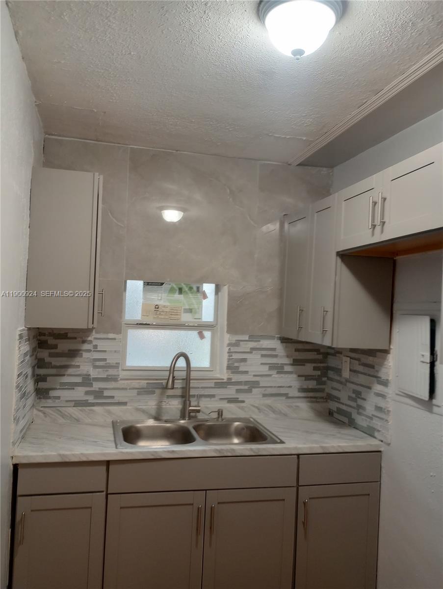 1918 Northwest 82nd Street Miami, FL 33147 - Photo 4 of 15 a kitchen with sink and cabinets