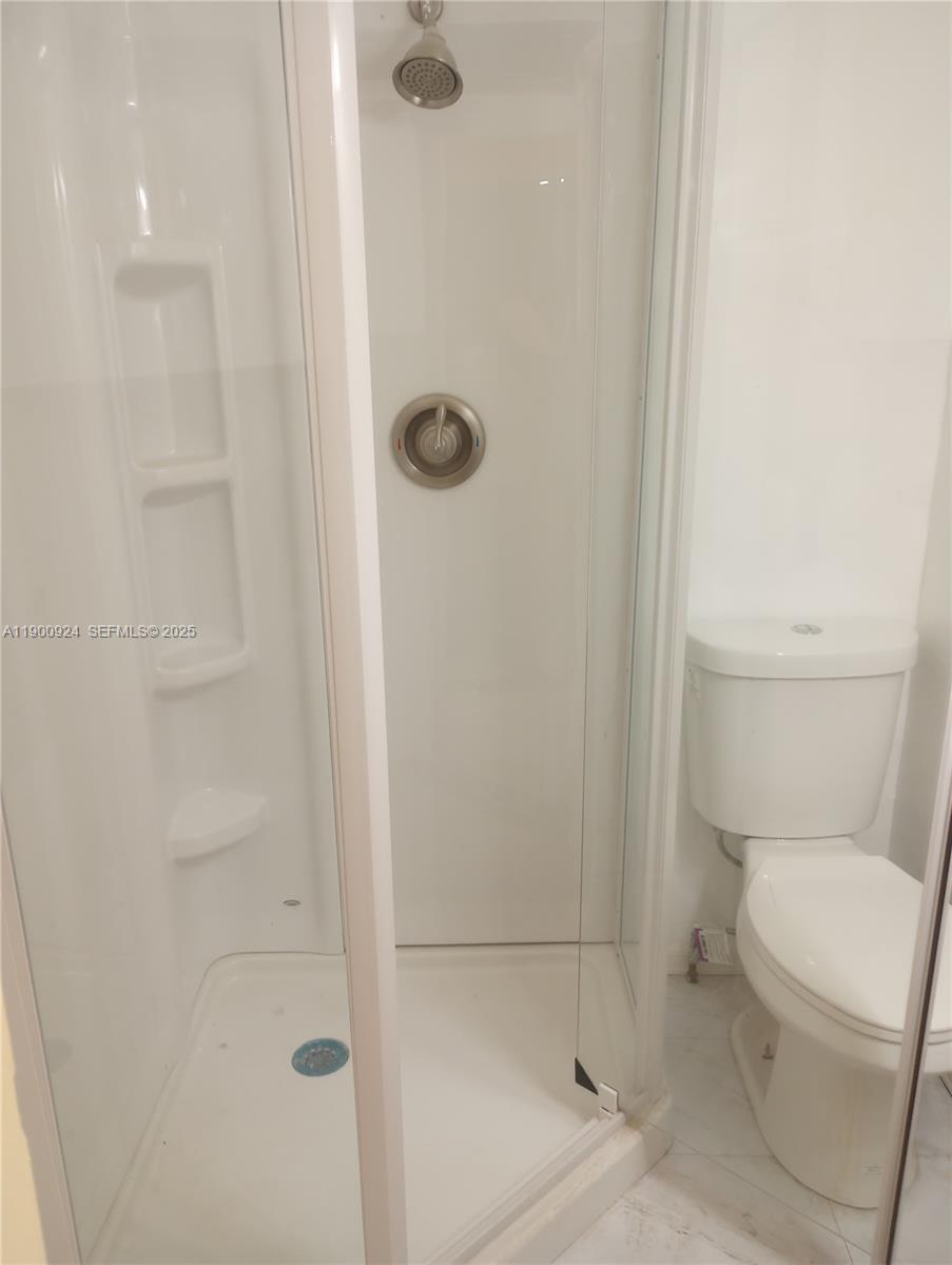 1918 Northwest 82nd Street Miami, FL 33147 - Photo 6 of 15 a bathroom with a toilet and shower