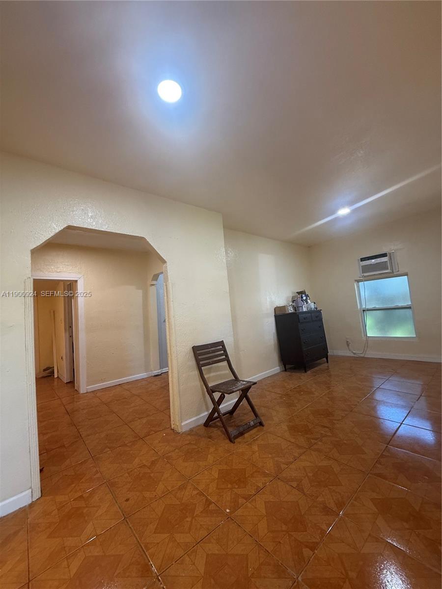 1918 Northwest 82nd Street Miami, FL 33147 - Photo 8 of 15 a view of a room with a hanging light and hardwood