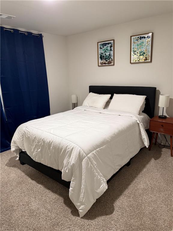 2957 Cottage Lane Atlanta, GA 30337 - Photo 15 of 21 a large bed sitting in a bedroom and a table