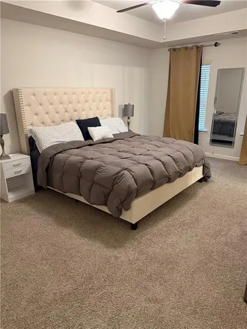 a bedroom with a bed and mirror