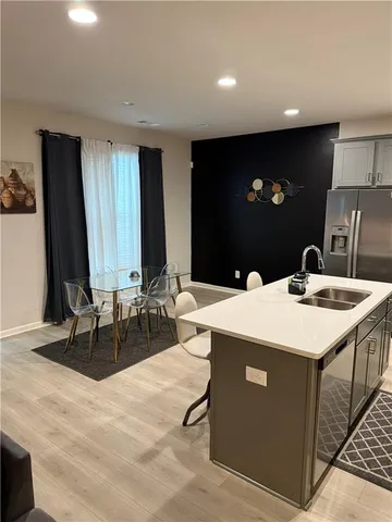 a kitchen with a sink and a refrigerator
