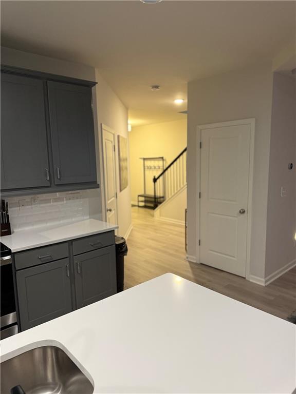 2957 Cottage Lane Atlanta, GA 30337 - Photo 5 of 21 a kitchen with a sink and wooden cabinets