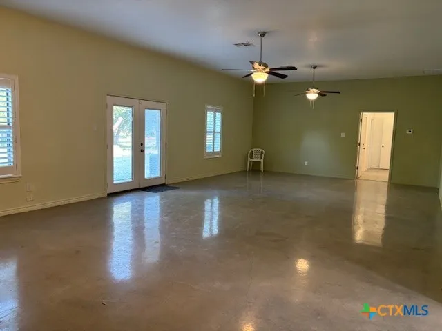 a view of a livingroom with a ceiling fan and window
