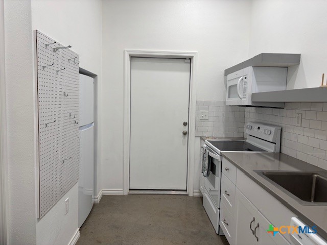 17307 Old 81, Unit D Troy, TX 76579 - Photo 5 of 6 a kitchen with stainless steel appliances granite countertop a sink and a refrigerator