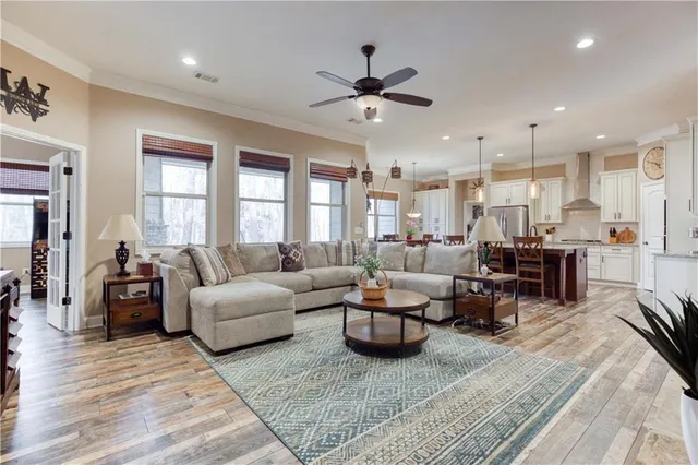 a kitchen with stainless steel appliances granite countertop a sink a stove and cabinets