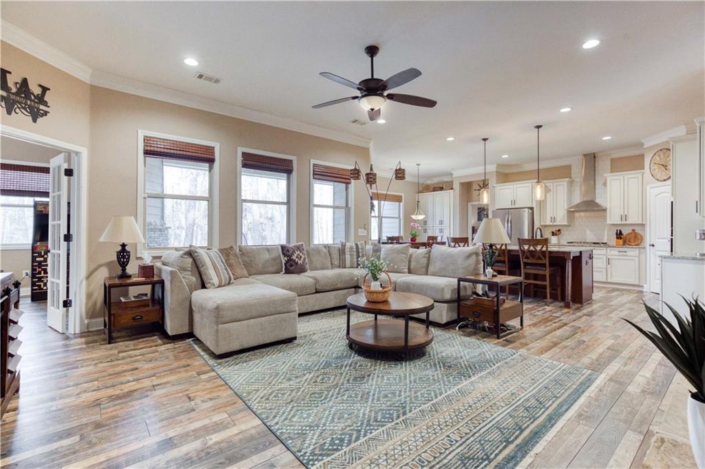 390 Herring Road Grayson, GA 30017 - Photo 16 of 59 a living room with furniture kitchen view and a wooden floor