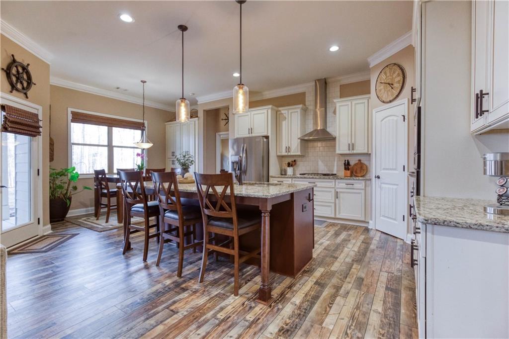 390 Herring Road Grayson, GA 30017 - Photo 17 of 59 a large kitchen with lots of counter space a dining table and chairs