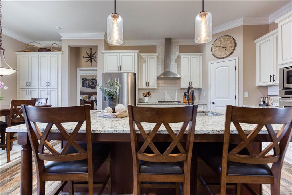 390 Herring Road Grayson, GA 30017 - Photo 18 of 59 a view of a dining room with furniture and wooden floor