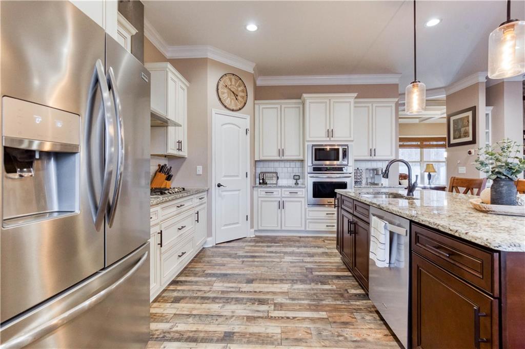 390 Herring Road Grayson, GA 30017 - Photo 20 of 59 a kitchen with stainless steel appliances granite countertop a refrigerator a stove and a sink with dishwasher
