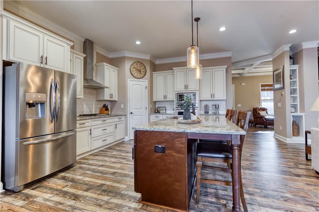 390 Herring Road Grayson, GA 30017 - Photo 21 of 59 a kitchen with stainless steel appliances granite countertop a refrigerator a sink dishwasher a stove and a refrigerator with wooden floor