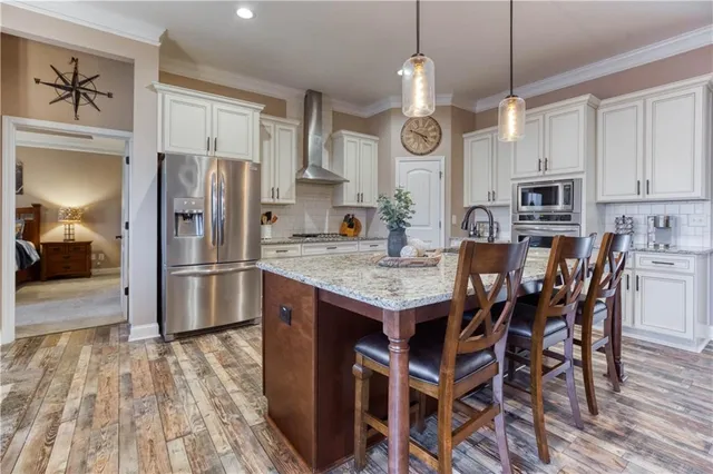 a spacious bedroom with a bed and a flat screen television