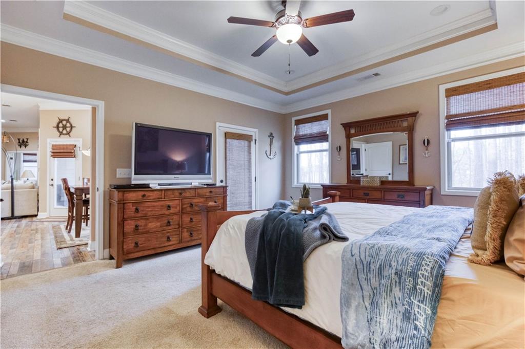 390 Herring Road Grayson, GA 30017 - Photo 25 of 59 a spacious bedroom with a bed and a flat screen television