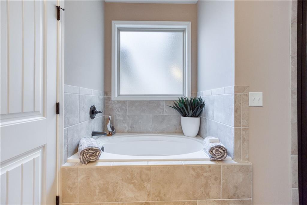 390 Herring Road Grayson, GA 30017 - Photo 28 of 59 a bath tub sitting in a bathroom next to a sink