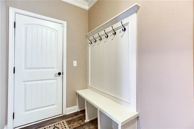 a bathroom with a granite countertop toilet sink and mirror
