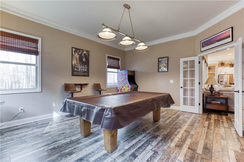 390 Herring Road Grayson, GA 30017 - Photo 36 of 59 a spacious bedroom with a bed a table and a large window