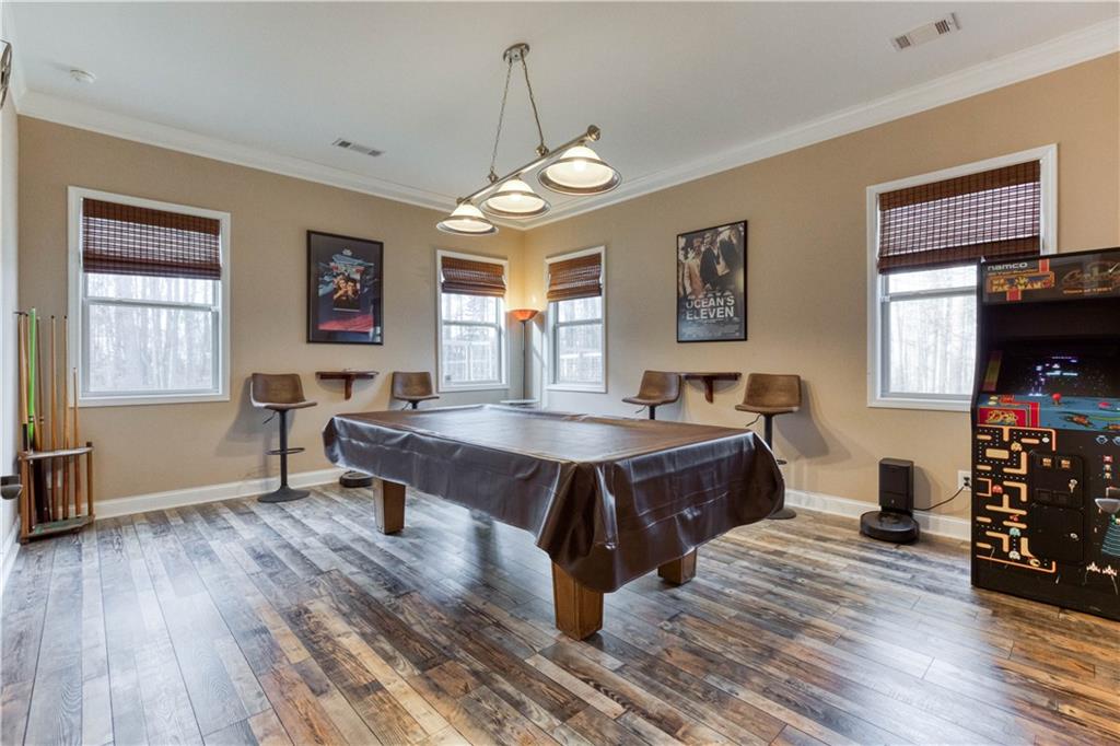 390 Herring Road Grayson, GA 30017 - Photo 37 of 59 a spacious bedroom with a bed and wooden floor