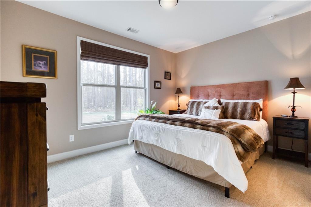 390 Herring Road Grayson, GA 30017 - Photo 39 of 59 a bed sitting in a bedroom next to a window