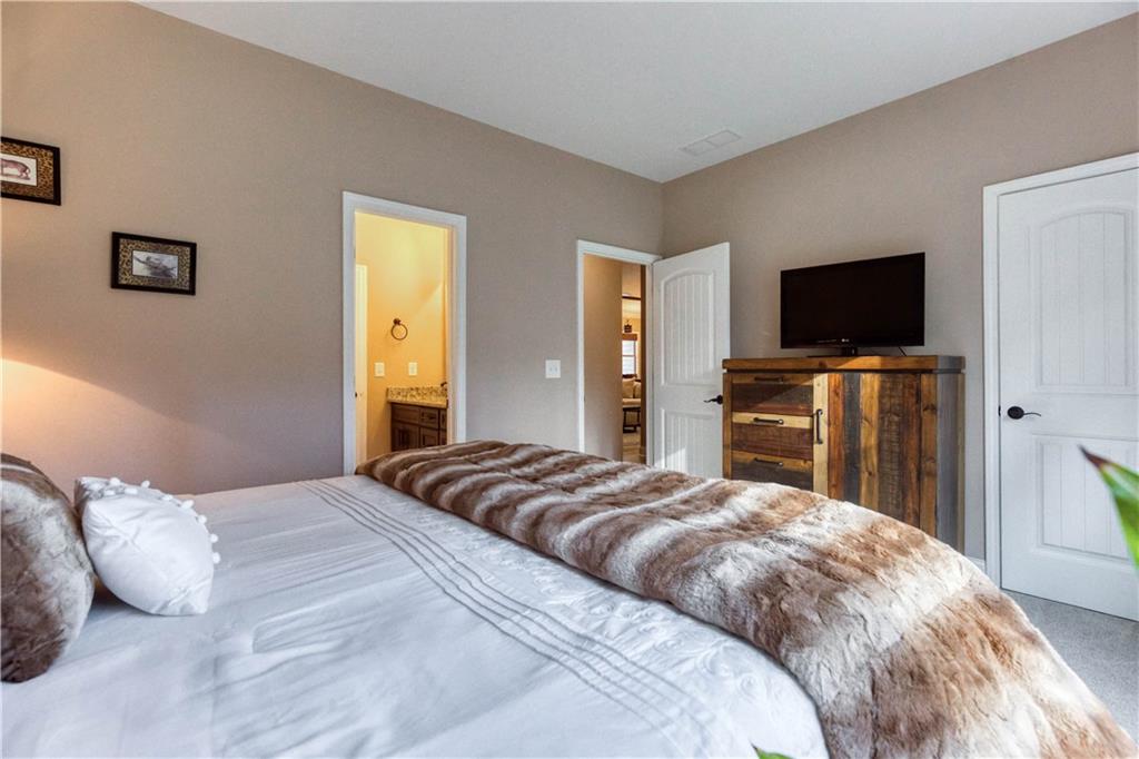 390 Herring Road Grayson, GA 30017 - Photo 40 of 59 a bedroom with a bed and a flat screen tv