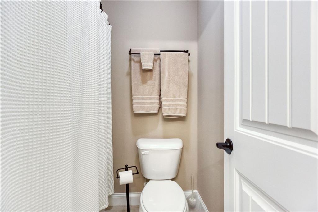 390 Herring Road Grayson, GA 30017 - Photo 43 of 59 a bathroom with a toilet sink and mirror
