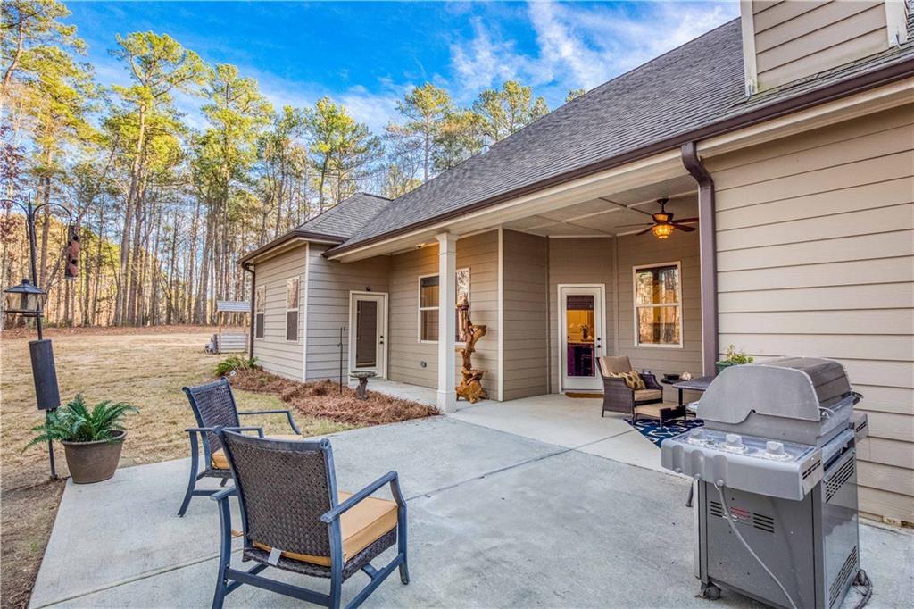 390 Herring Road Grayson, GA 30017 - Photo 48 of 59 a view of a patio with table and chairs and potted plants