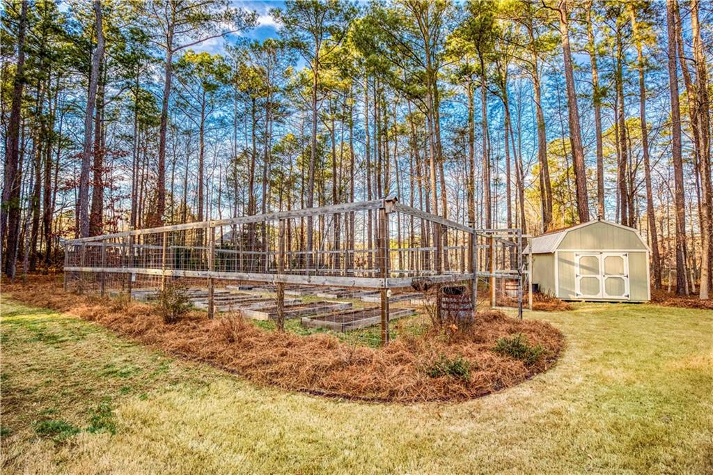390 Herring Road Grayson, GA 30017 - Photo 53 of 59 a view of a swimming pool with a bench and trees in the background